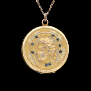 a gold medallion with a woman's face on it