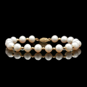 a bracelet with pearls and gold beads