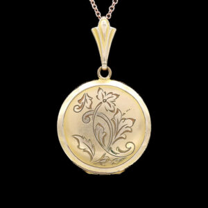 a gold locke with a flower design on it