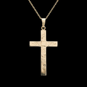 a gold cross pendant on a black background