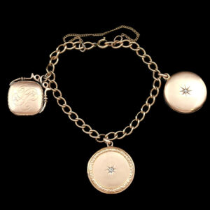 a gold bracelet with two charms and a star