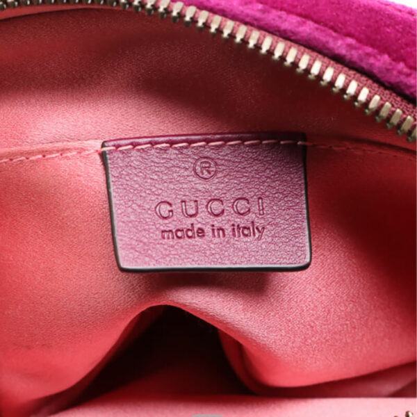 a gucci bag with a tag on it
