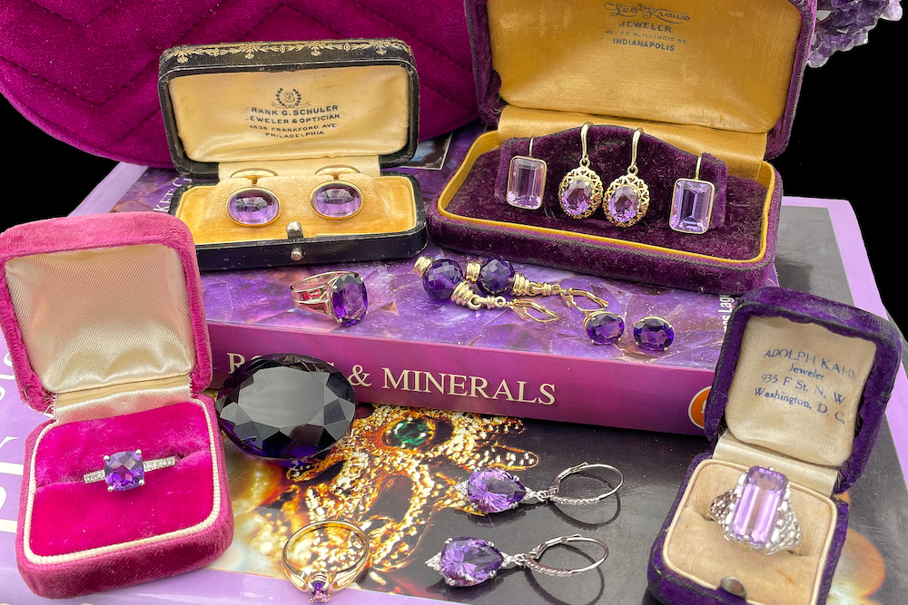 a table topped with lots of purple jewelry