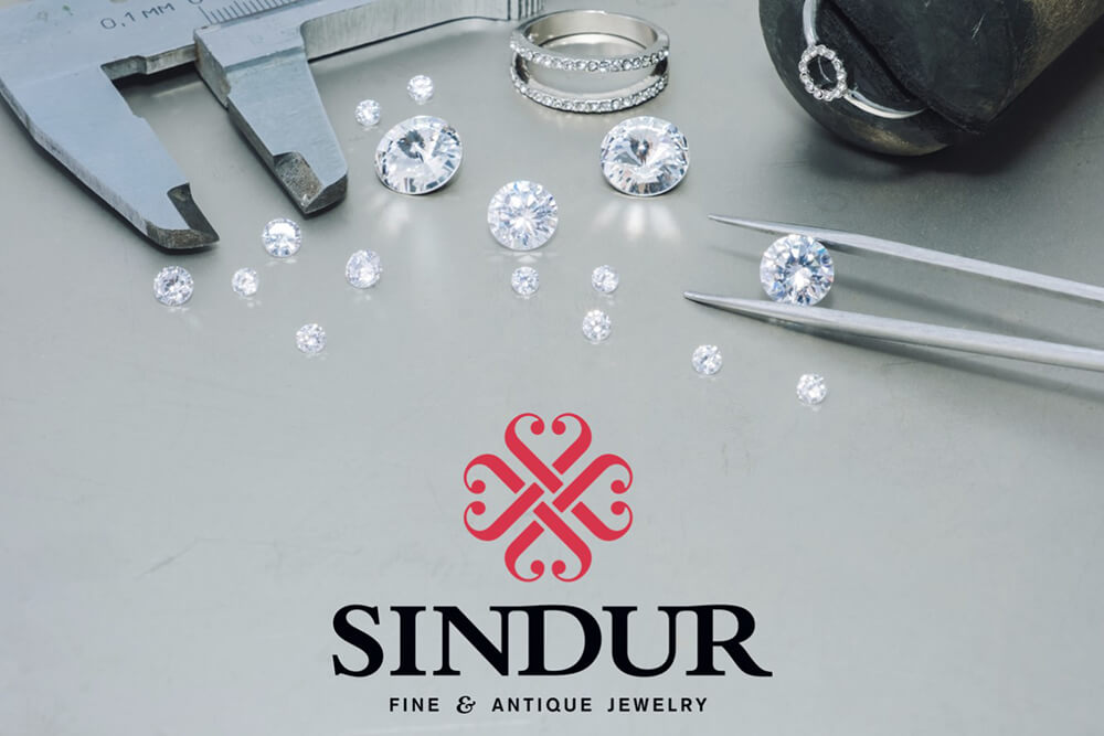 a pair of pliers and some diamonds on a table