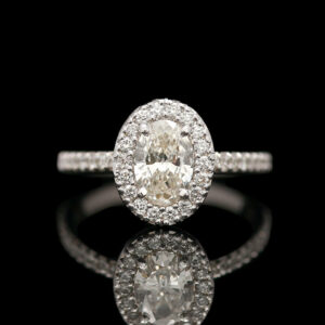 an oval diamond ring with diamonds surrounding it