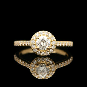 a yellow gold ring with diamonds on it