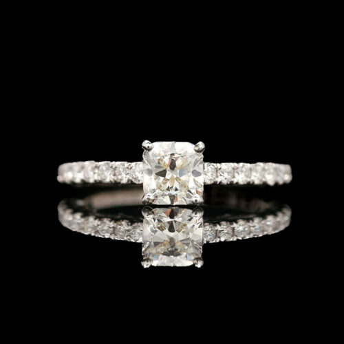 an engagement ring with a cushion cut diamond