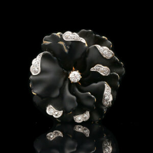 a black and white brooch with diamonds on it