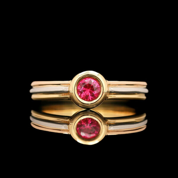 a close up of a ring with a pink stone