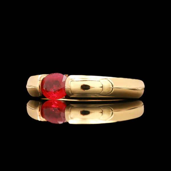 two gold rings with a red stone in the middle