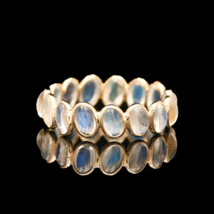 a gold ring with blue and white stones
