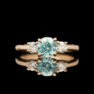 a blue diamond ring with three diamonds on it