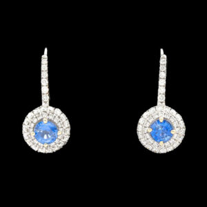 a pair of earrings with blue stones and diamonds