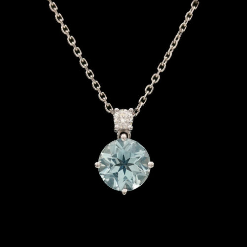 a necklace with a blue topazte and diamonds