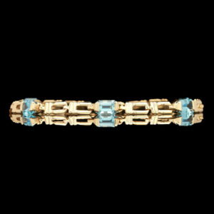 a yellow gold bracelet with blue stones