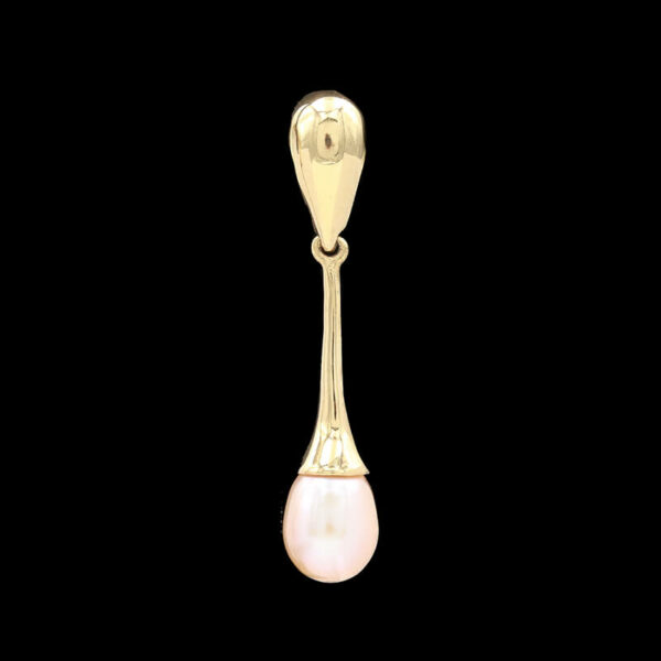 a gold spoon with a pearl hanging from it