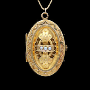 an antique gold locke with pearls on a chain