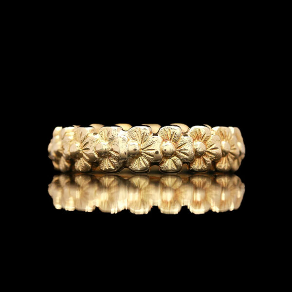 a gold ring with flowers on it