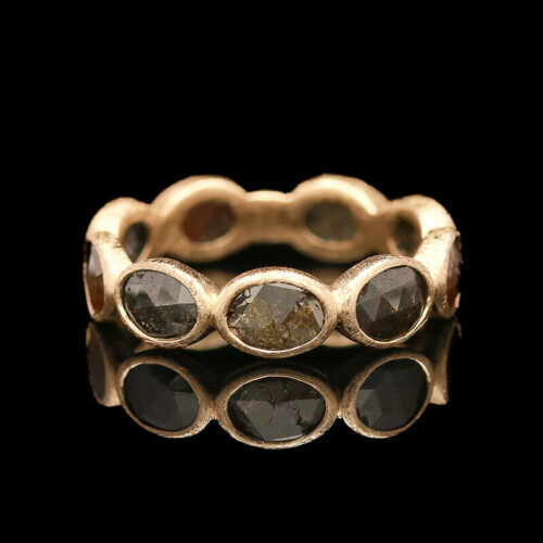 a gold ring with three stones on it