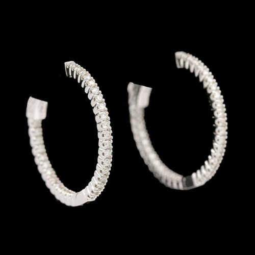 a pair of white gold and diamond hoop earrings
