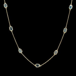 a gold chain with blue stones on it