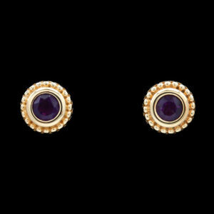 a pair of gold and purple stone earrings