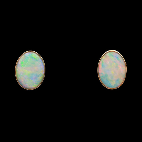 a pair of opalite stud earrings on a black background