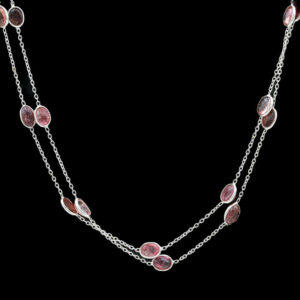 a long necklace with pink stones on it