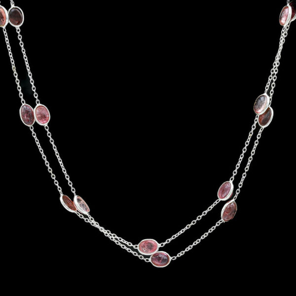 a long necklace with pink stones on it