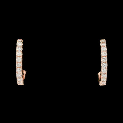 a pair of diamond hoop earrings on a black background
