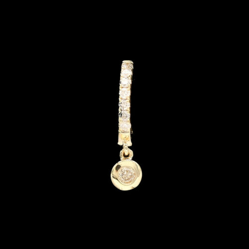 a yellow gold charm with diamonds on a black background