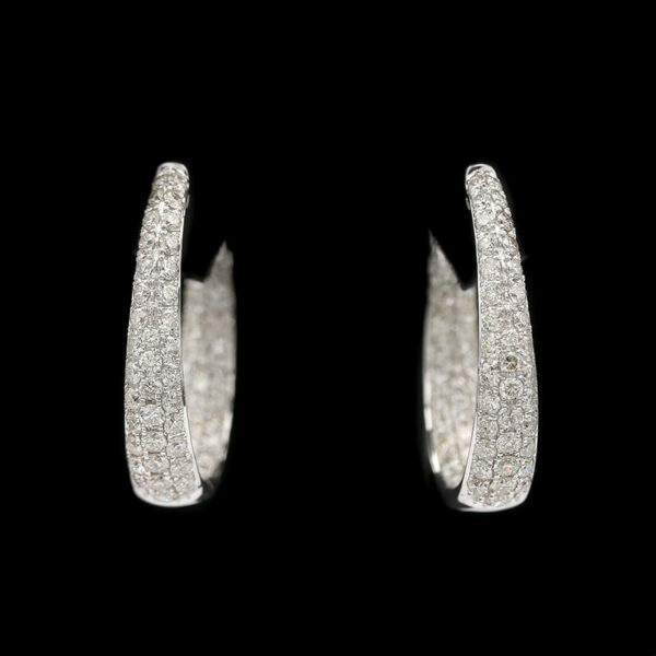 a pair of white gold diamond hoop earrings