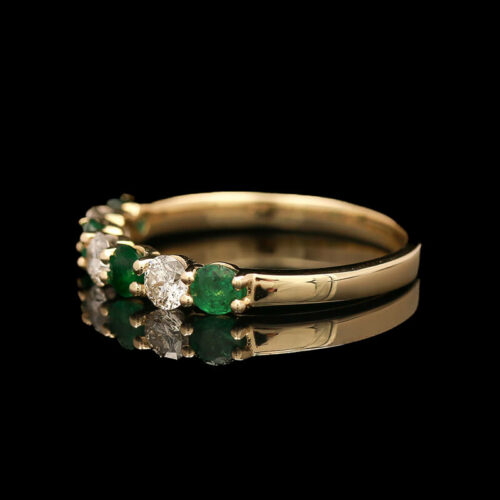 an emerald and diamond three stone ring