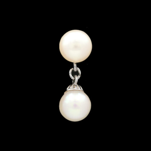 a pair of white pearls hanging from a silver chain
