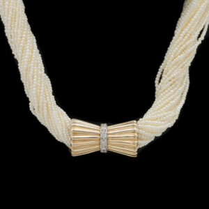 a white necklace with a bow on it