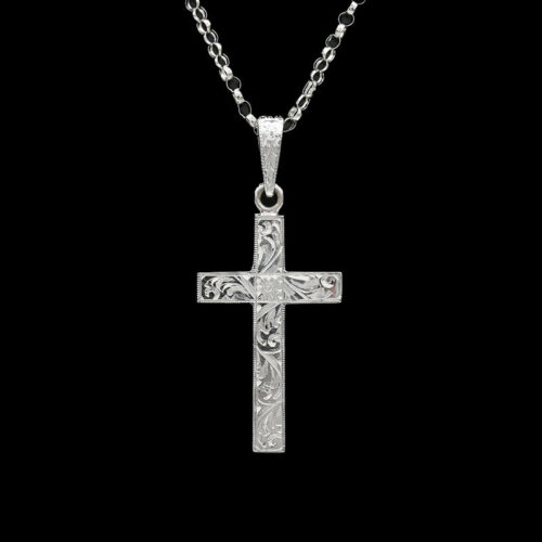 a silver cross on a black background