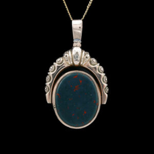 a pendant with a blue stone in the center