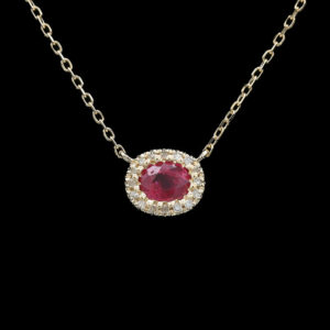 a necklace with a red stone and white diamonds