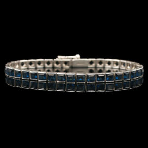 a bracelet with blue stones on a black background