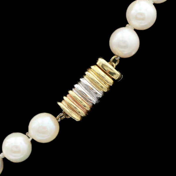 a necklace with pearls and gold beads