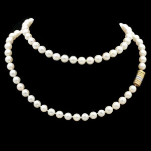 a white pearl necklace with a gold clasp