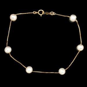 a gold chain bracelet with white pearls