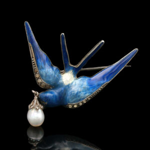 a blue bird with a pearl in its beak
