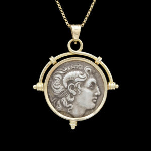 a roman coin pendant with a woman's face