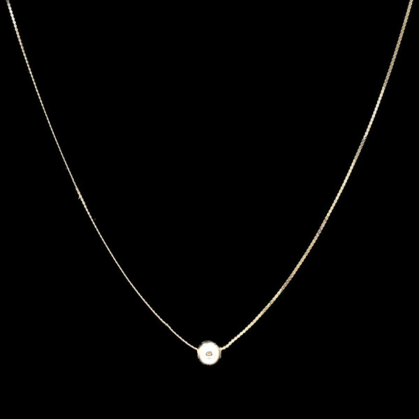 a gold necklace with a pearl on it