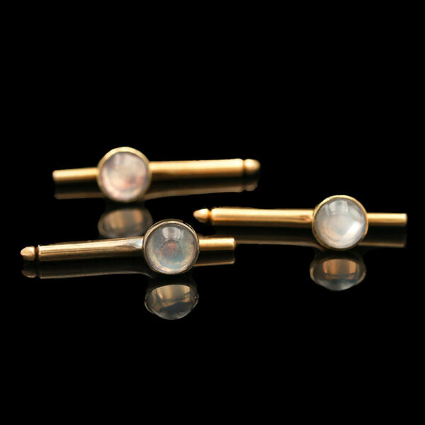 three gold - plated cufflinks with white mother of pearl beads