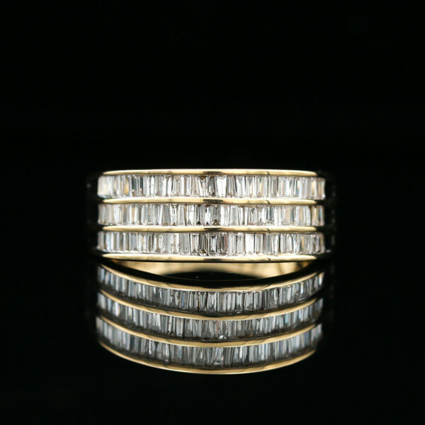 a gold ring with baguetts of diamonds