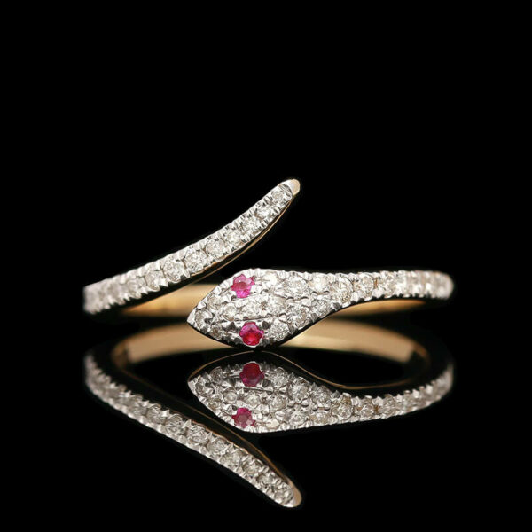 a diamond and ruby ring on a black background