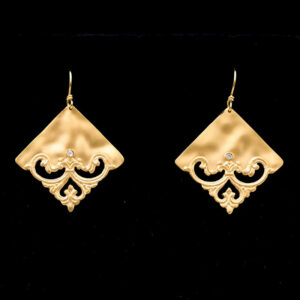 a pair of gold earrings with diamond accents