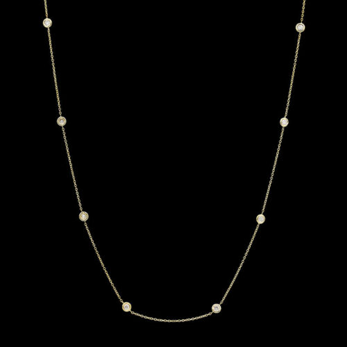a long necklace with pearls on a black background